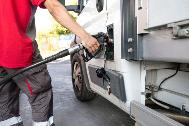 HVAC fleet driver fuels the company HVAC van with a fleet card at a gas station.