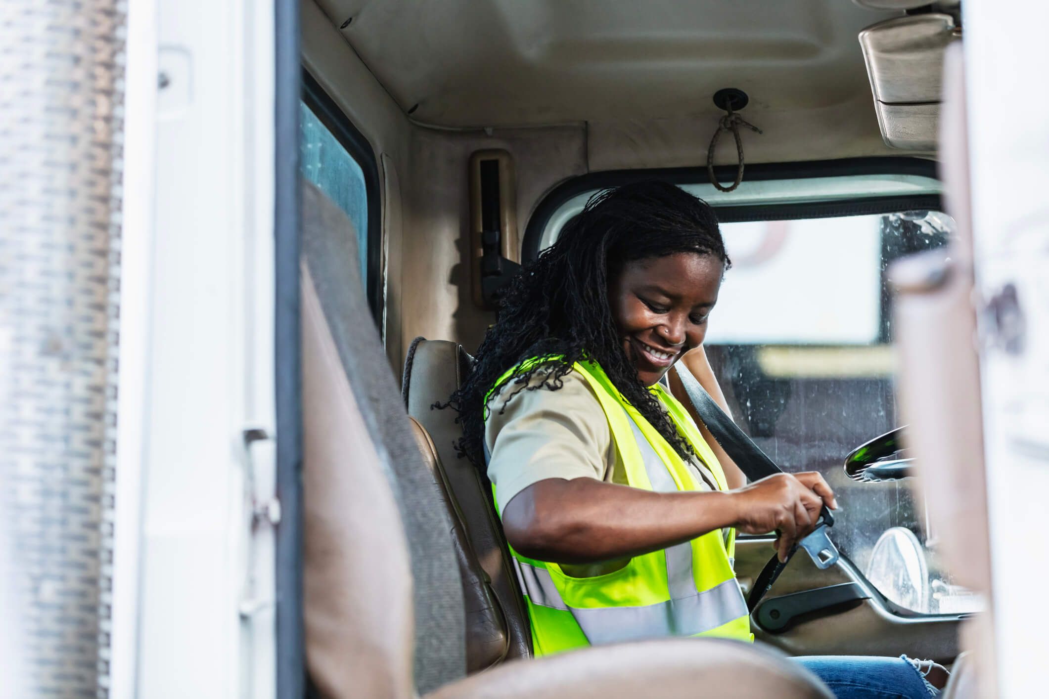 A truck driver prepares to drive her truck after fueling it with a fleet card.